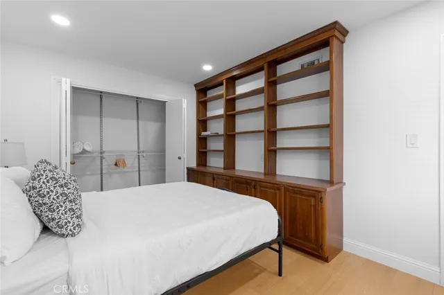 a bedroom with a bed and a potted plant