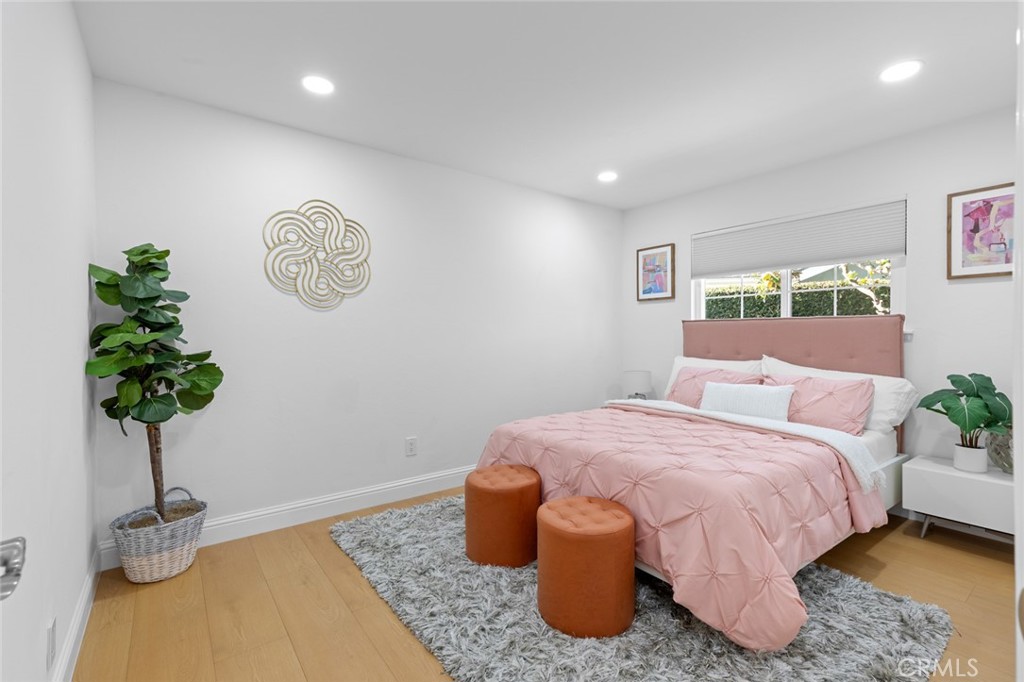 17131 Autumn Huntington Beach, CA 92647 - Photo 15 of 36 a bedroom with a bed and a potted plant