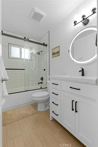 a spacious bedroom with a bed and a potted plant