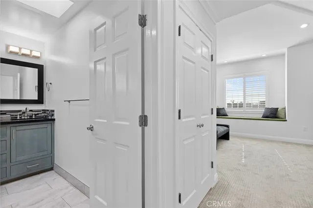 a bathroom with a granite countertop sink a mirror and a shower