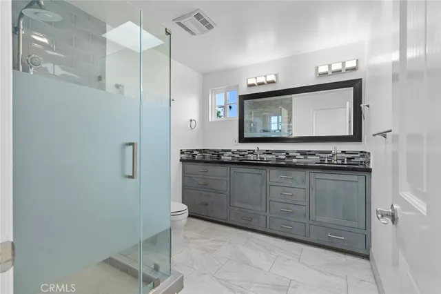 a spacious bedroom with a bed and a window