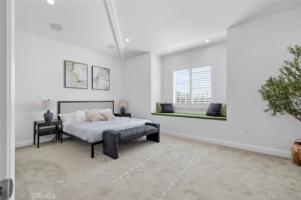 17131 Autumn Huntington Beach, CA 92647 - Photo 32 of 36 a spacious bedroom with a bed and a window