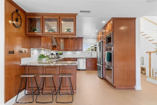 a kitchen with stainless steel appliances granite countertop a refrigerator and microwave