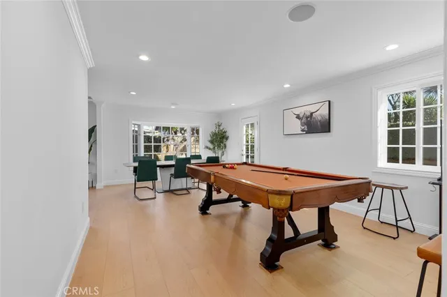 a room with furniture pool table and windows