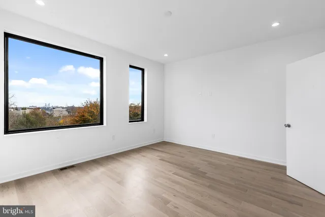 a view of a room with wooden floor and window