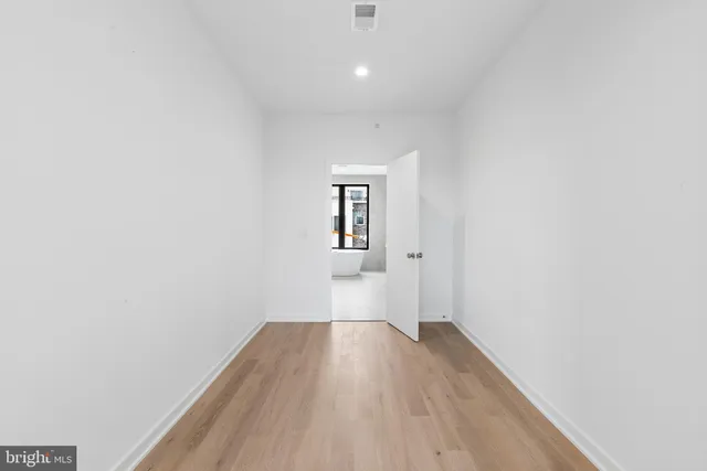 a view of wooden floor and windows in a room
