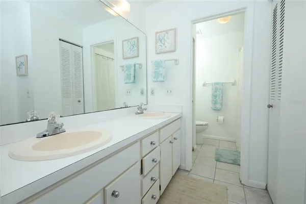 a bathroom with a granite countertop toilet and a shower