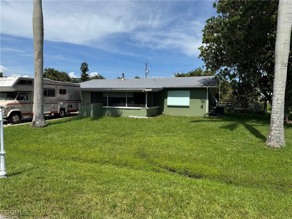 a view of a house with a yard and sitting area