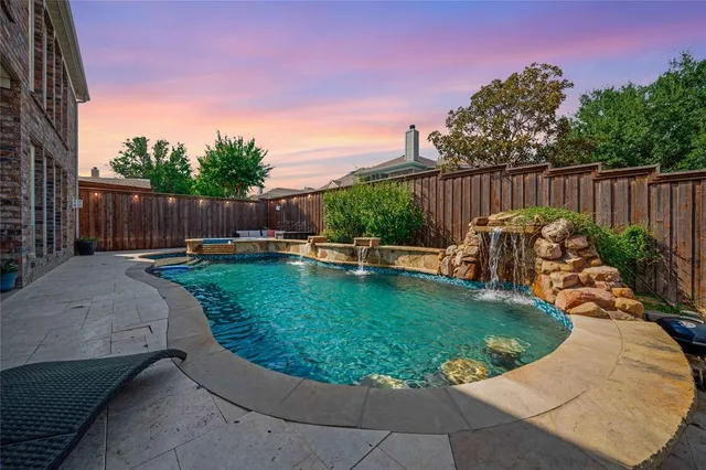 a view of a backyard with swimming pool