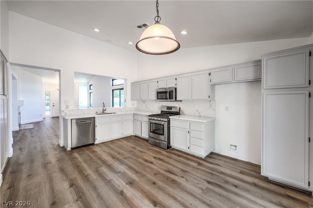 1900 Cardinal Point Street Henderson, NV 89012 - Photo 11 of 32 A pristine kitchen features sleek stainless steel appliances, abundant cabinetry, and durable laminate flooring.