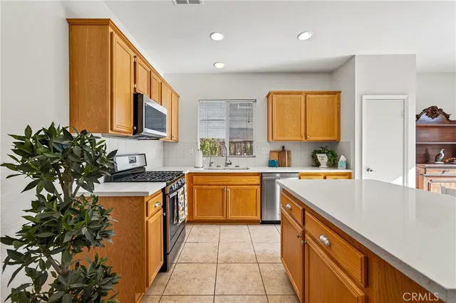 a kitchen with stainless steel appliances granite countertop a sink and a stove