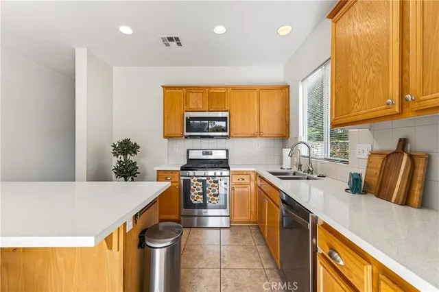 a room with furniture and view of kitchen