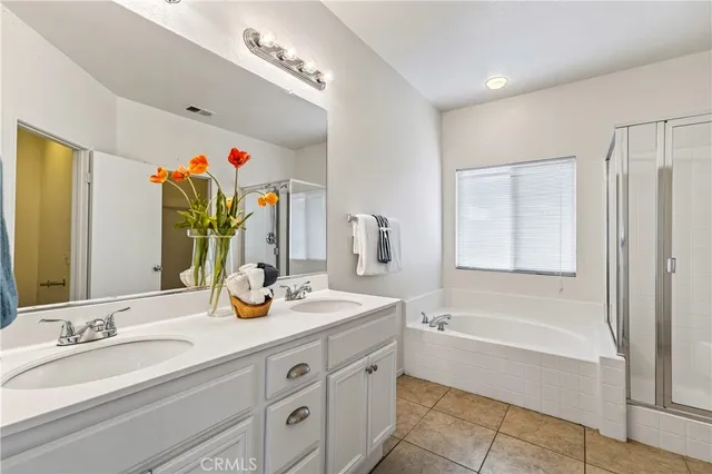 a view of a patio with a table and chairs under an umbrella