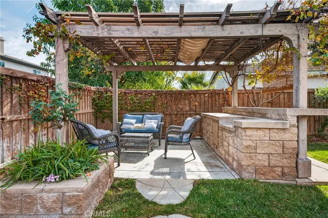 a view of a house with backyard and sitting area