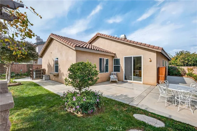 a backyard of a house with table and chairs