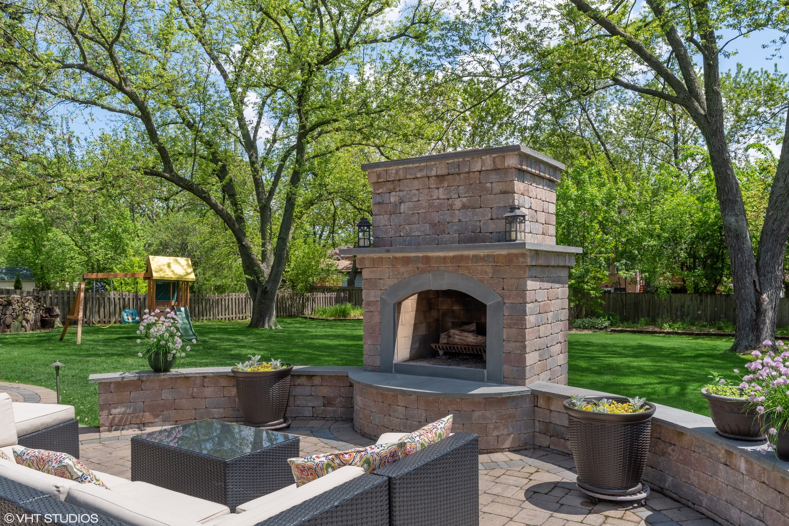 417 Warren Road Glenview, IL 60025 - Photo 22 of 24 a view of a patio with table and chairs potted plants and a large tree