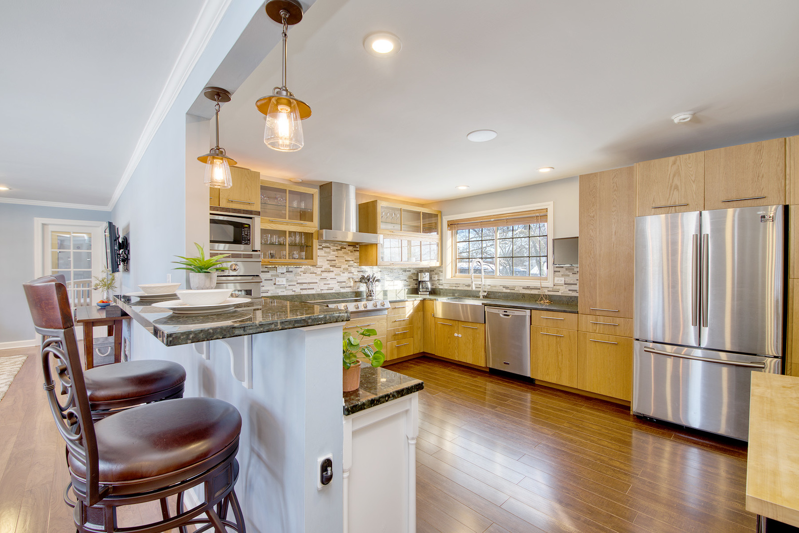417 Warren Road Glenview, IL 60025 - Photo 5 of 24 a kitchen with a sink cabinets and wooden floor