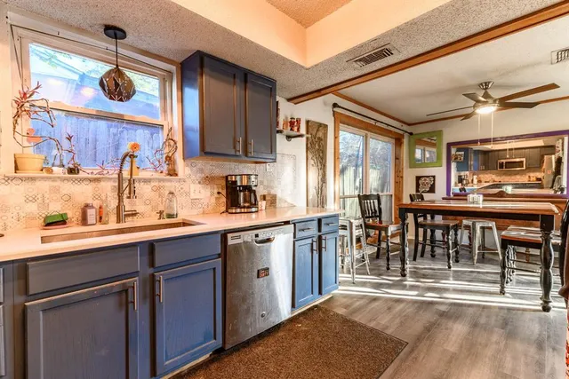 a kitchen with a sink appliances and cabinets