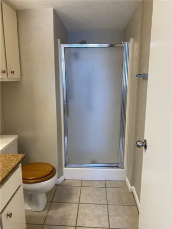 a bathroom with a toilet and a shower