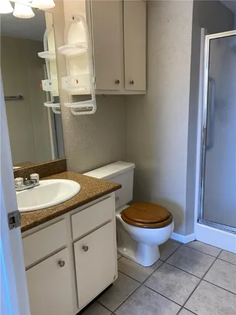 a bathroom with a sink toilet and a mirror