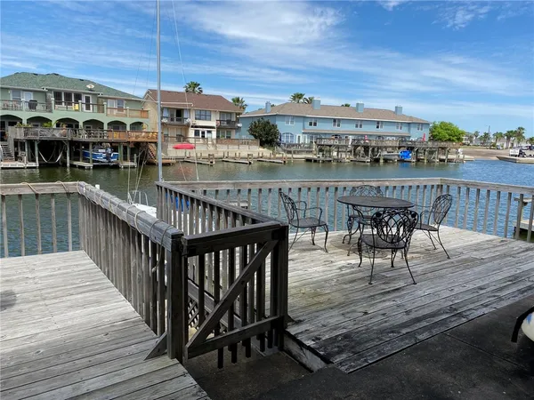 a balcony with table and chairs