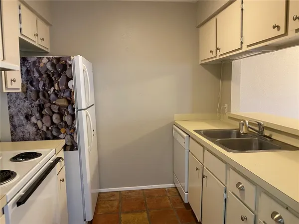 a kitchen with a sink and a refrigerator