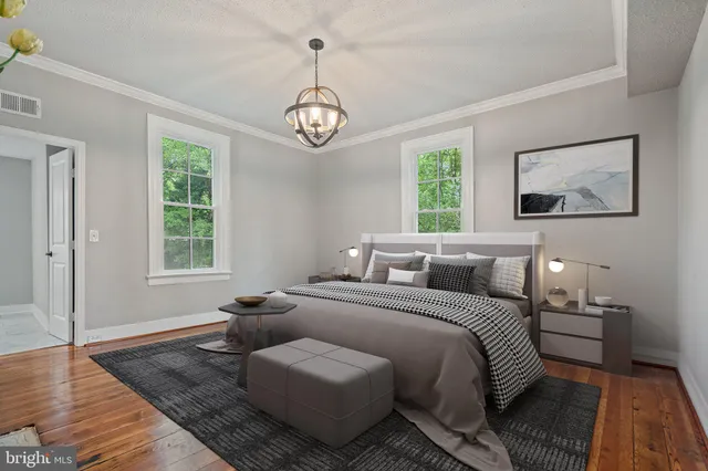 a living room with furniture wooden floor and a window