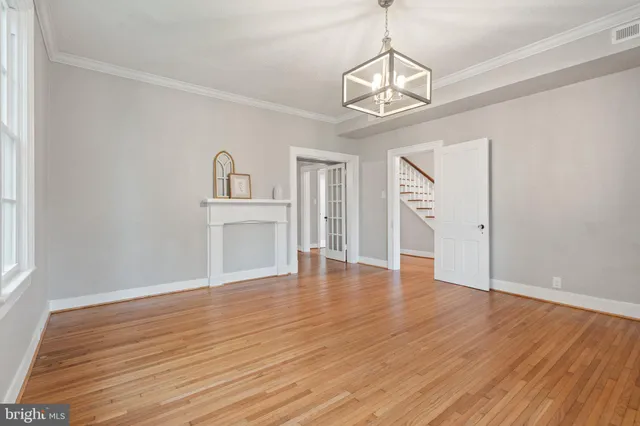 a view of a livingroom with wooden floor and a ceiling fan