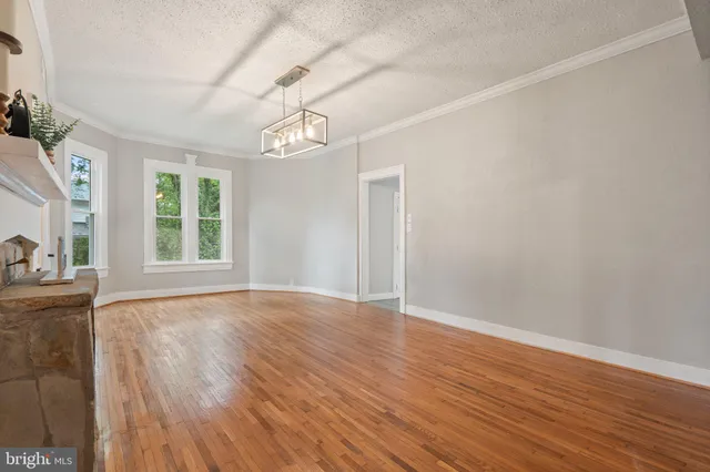 a view of a room with wooden floor