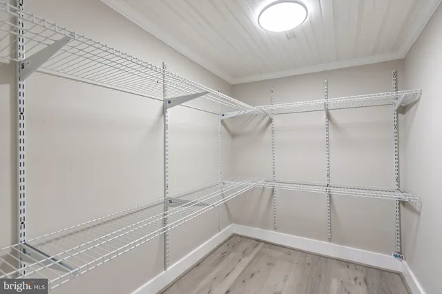 an empty room with wooden floor and a window