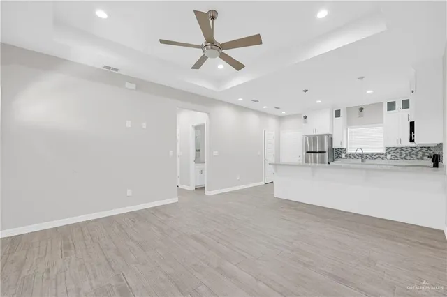 a kitchen with stainless steel appliances a refrigerator stove top oven and cabinets