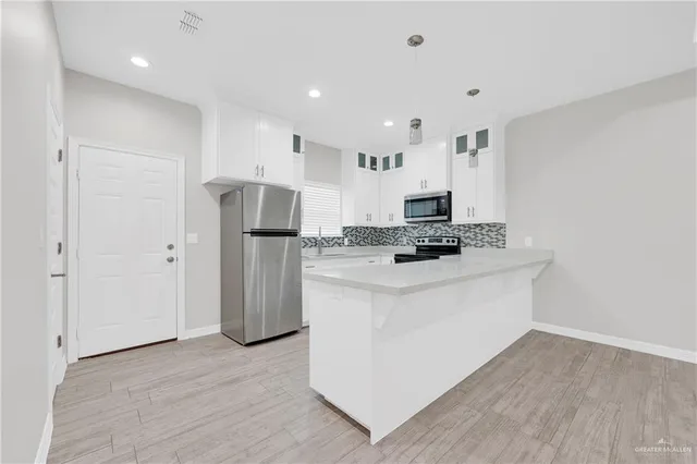 a kitchen with granite countertop a sink and a stove top oven