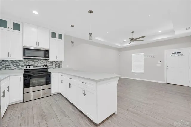 a view of a double vanity sink a mirror and cabinets