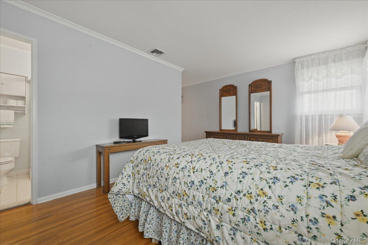 17 Avon Road Farmingdale, NY 11735 - Photo 18 of 46 a bedroom with a bed and a flat screen tv
