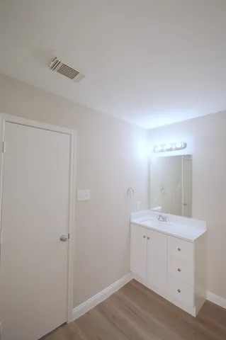 a view of a bathroom with a sink a mirror and a vanity