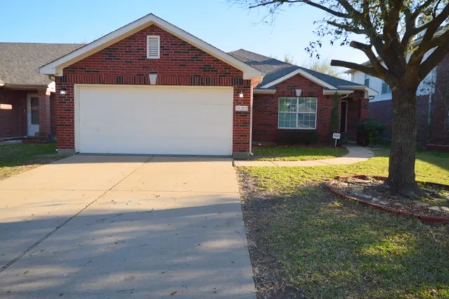 a front view of a house with yard and garage