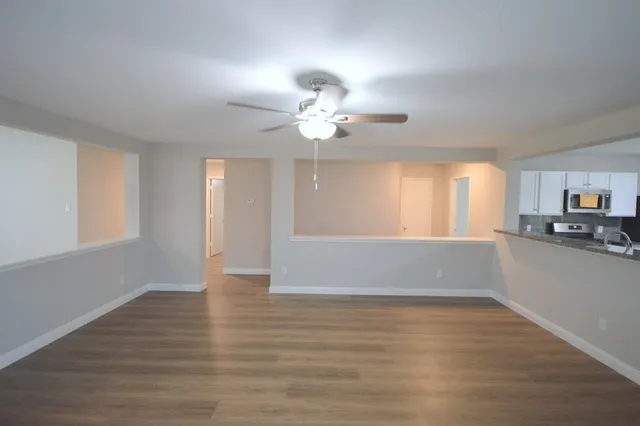 a view of kitchen and window with a ceiling fan