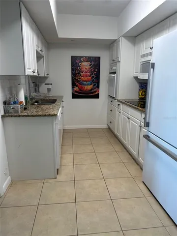 a kitchen with stainless steel appliances a sink stove and cabinets
