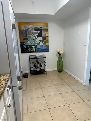 a living room with a couch and a stove next to a window