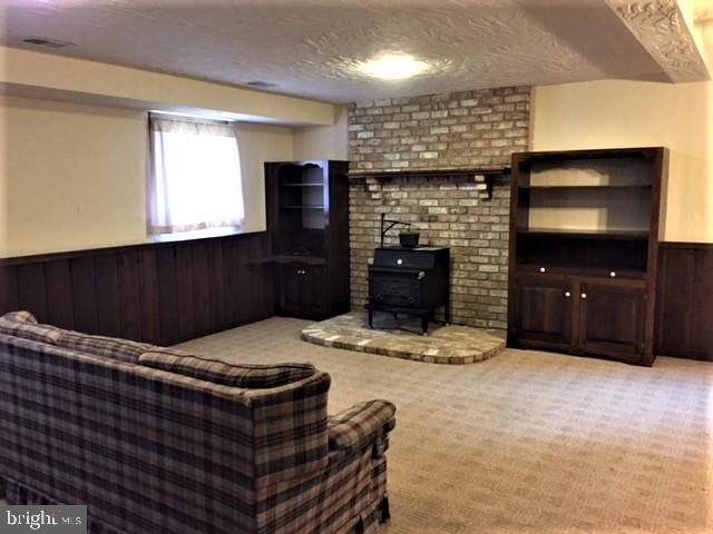 4100 Sells Mill Road Taneytown, MD 21787 - Photo 8 of 22 Lower Level 1 Family Room and Fireplace-Wood Stove