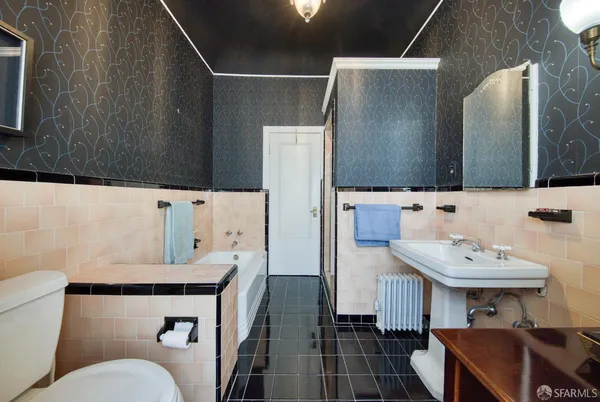 a bathroom with a sink toilet and mirror