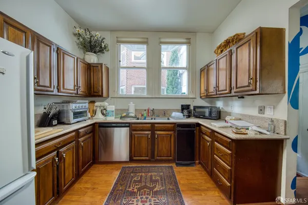 a kitchen with stainless steel appliances granite countertop a sink stove microwave and cabinets