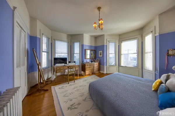 a bed room with a bed and a chair