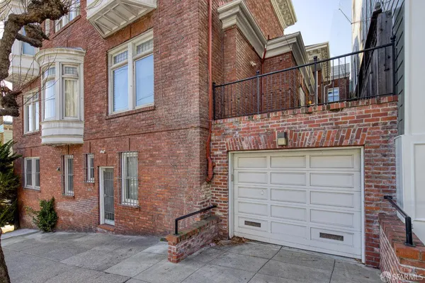 a view of a brick house with large windows