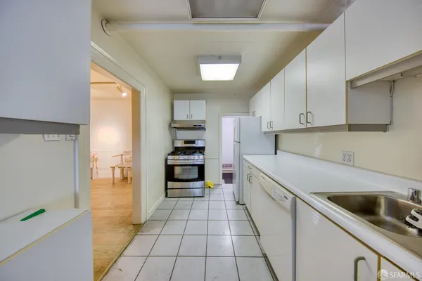 a kitchen with stainless steel appliances a refrigerator sink and cabinets