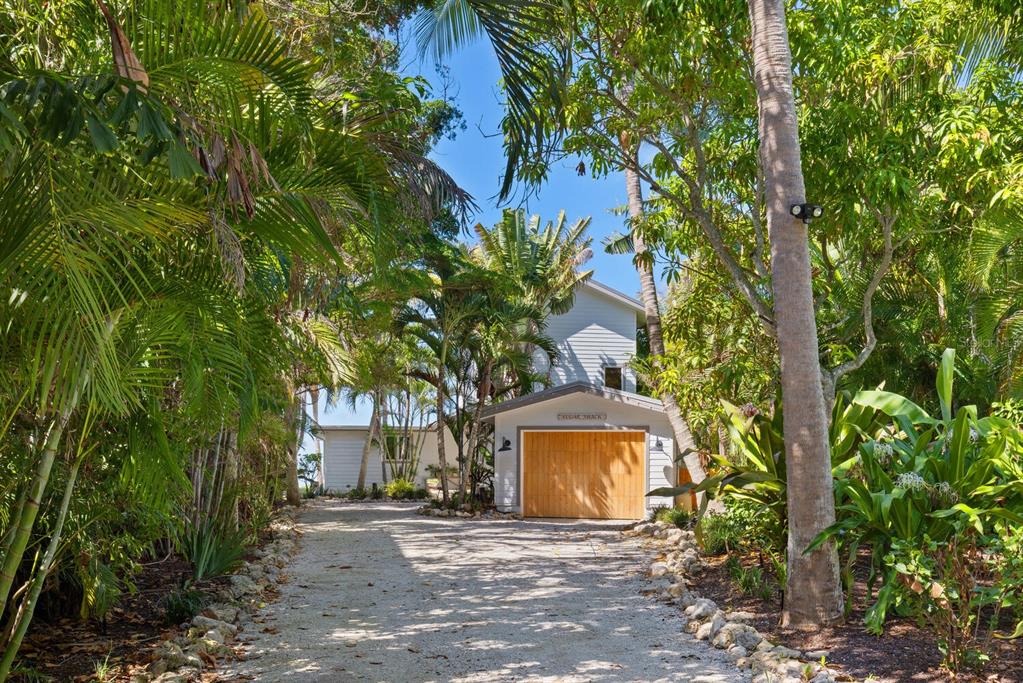 7314 Point Of Rocks Road Sarasota, FL 34242 - Photo 17 of 22 a front view of a house with a yard