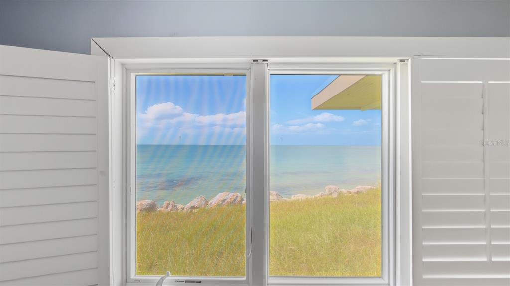 7314 Point Of Rocks Road Sarasota, FL 34242 - Photo 6 of 22 a bathroom with a glass door