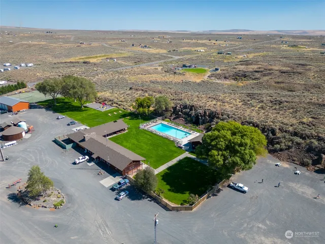 an aerial view of ocean beach and residential houses with outdoor space