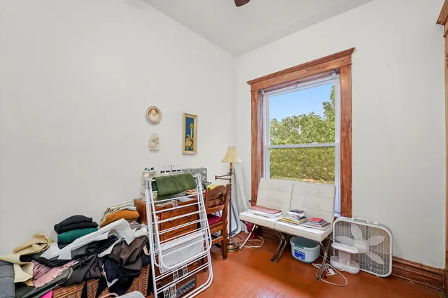 a bedroom with furniture and a window