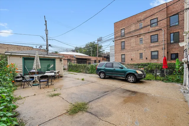 a view of a house with a patio and a yard